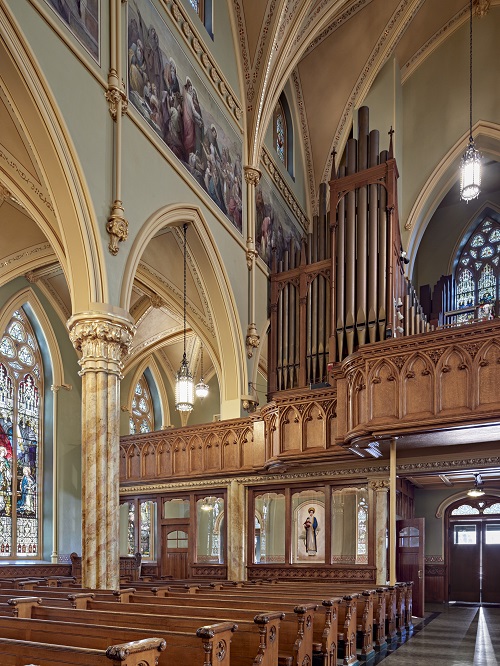 Detail of woodgrained choir loft and cry room