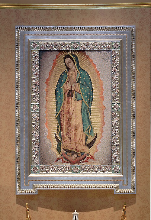 Image of Our Lady of Guadalupe with the back wall and frame decorated with Castillian roses from her mantel. 